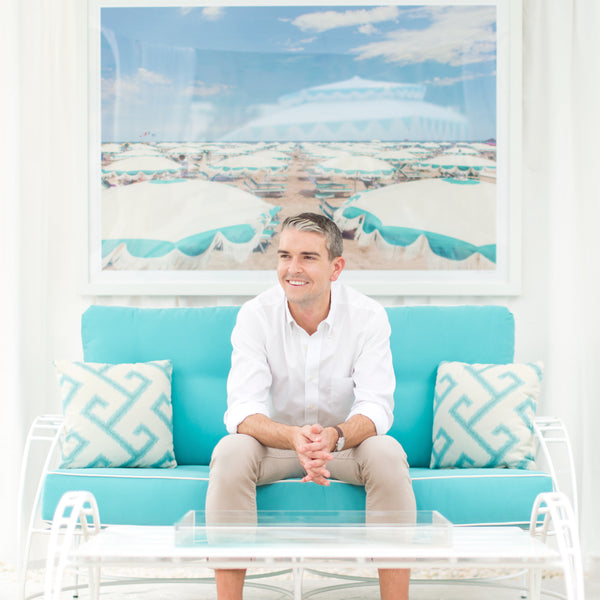 Image of Gray Main sitting on turquoise sofa