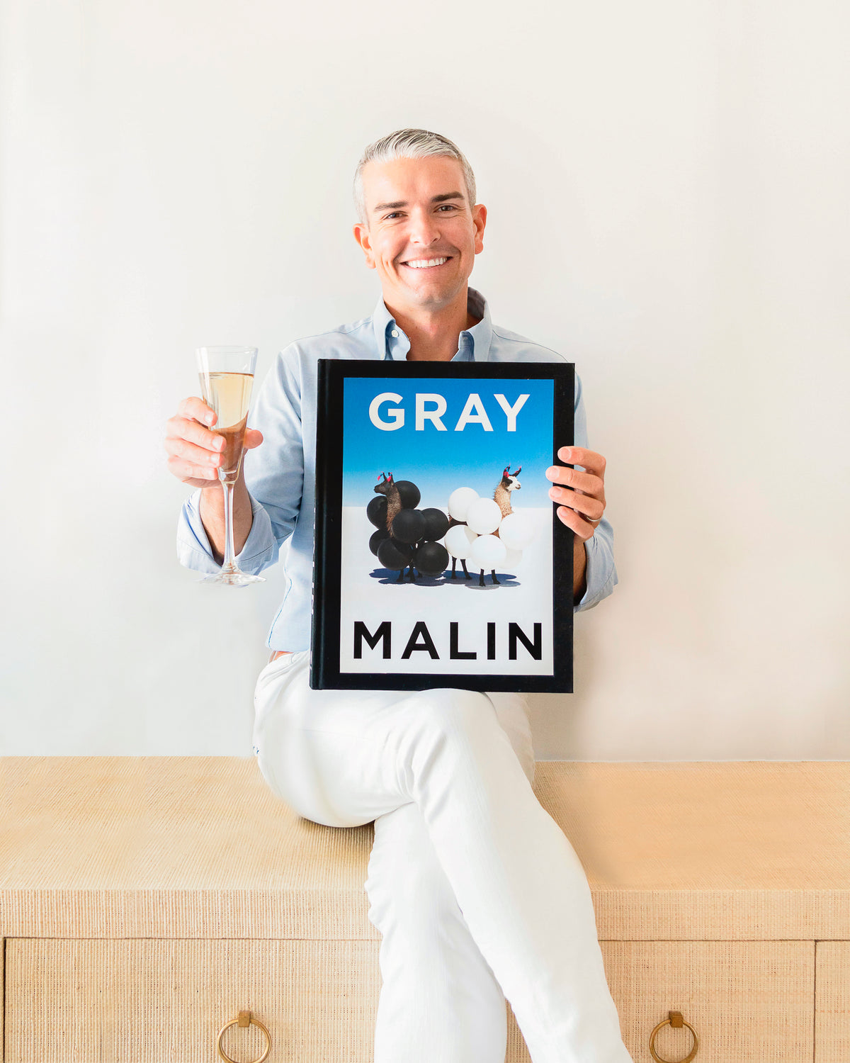 Gray Malin holding book