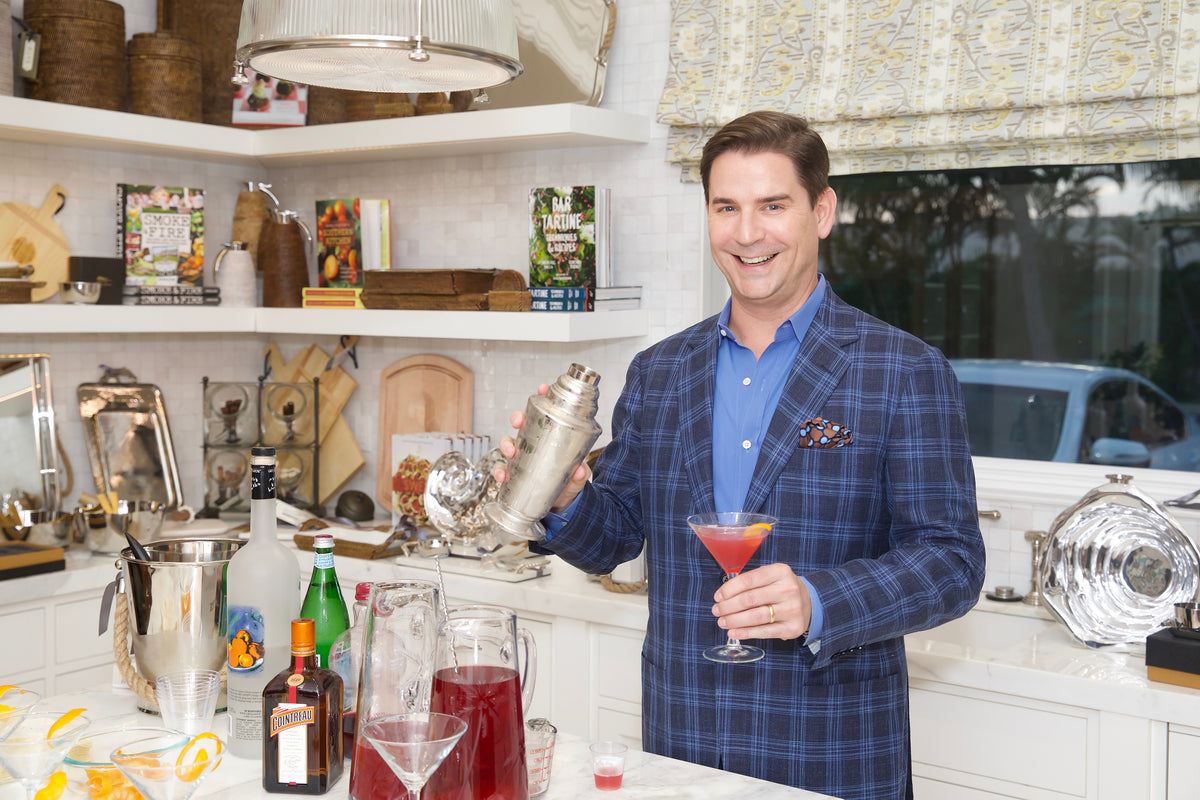 Image of man in kitchen mixing drinks