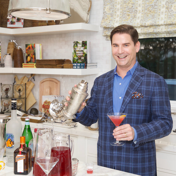 Image of man in kitchen mixing drinks