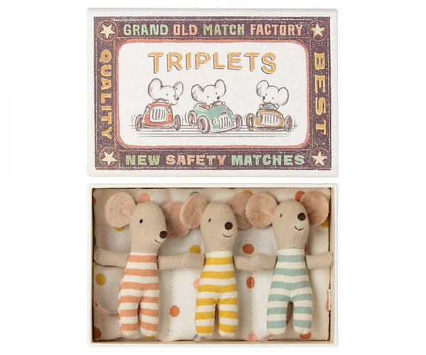 The Maileg Baby Triplets in Box, an ideal gift for kids, comes in a matchbox labeled "TRIPLETS" and features charming illustrations of mice driving cars. Inside, you'll find three adorable baby mice triplets dressed in orange, yellow, and green striped outfits. These delightful toys are crafted from recycled polyester by Maileg, making them an eco-friendly choice.