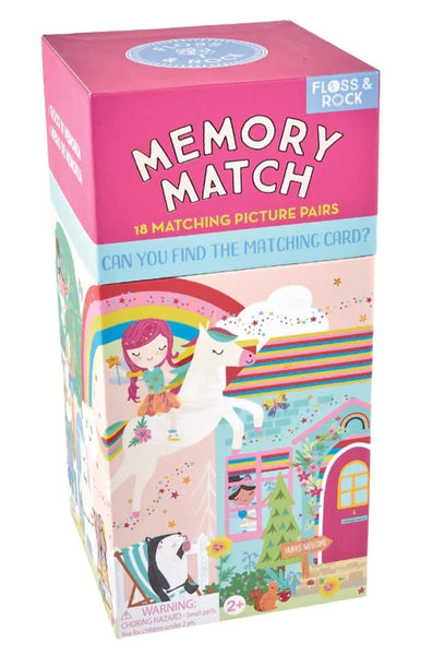 Box of "Floss & Rock Memory Match, Rainbow Fairy" game by Floss and Rock featuring colorful illustrations, including a Rainbow Fairy design, a unicorn, and children. Contains 18 matching picture pairs that help develop cognitive skills. Warning label about small parts for ages 2+.