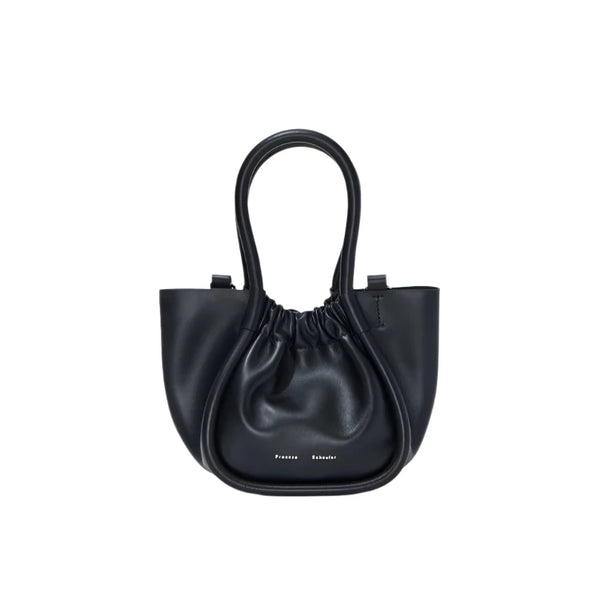 The Proenza Schouler Extra Small Ruched Tote in black calfskin features two handles and an adjustable shoulder strap. With minimalist branding and a curved, compact shape, this handbag from Proenza Schouler exudes understated elegance.