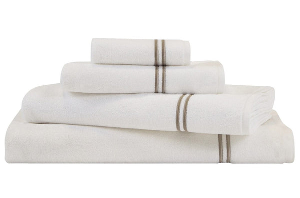 A stack of Frette Classic Bath Collection, White/Khaki towels from Frette, featuring brown stripe accents and made from absorbent cotton terry, are neatly arranged, perfect for a stylish bathroom space.