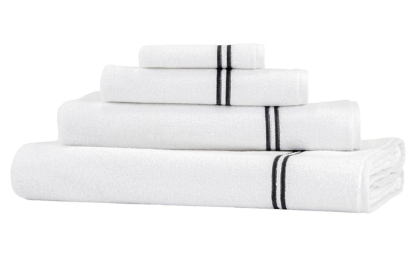 A stack of white towels in various sizes, folded neatly. Each towel from the Frette Classic Bath Collection, White/Grey features one or more black stripes near the edge, adding a touch of elegance to your luxurious bathroom accessory set.