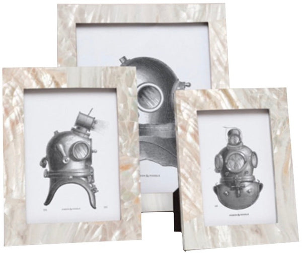 Three framed drawings of vintage diving helmets on a marble-like background, with each frame meticulously crafted from iridescent Pigeon & Poodle Aurora frames.