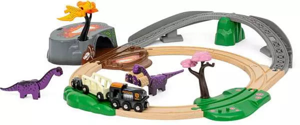 The Brio BRIO Dinosaur Adventure Set includes a toy train set with wooden tracks surrounded by dinosaur figures, trees, a mountain tunnel, and a bridge. The train itself features a black engine and two white cars.