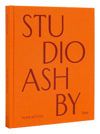 An orange book cover with the title "Studio Ashby: Home Art Soul" in large red letters, published by Rizzoli. The subtitle "HOME ART SOUL" is at the bottom, capturing the essence of vibrant interiors designed by renowned interior designer Ashley Hicks.