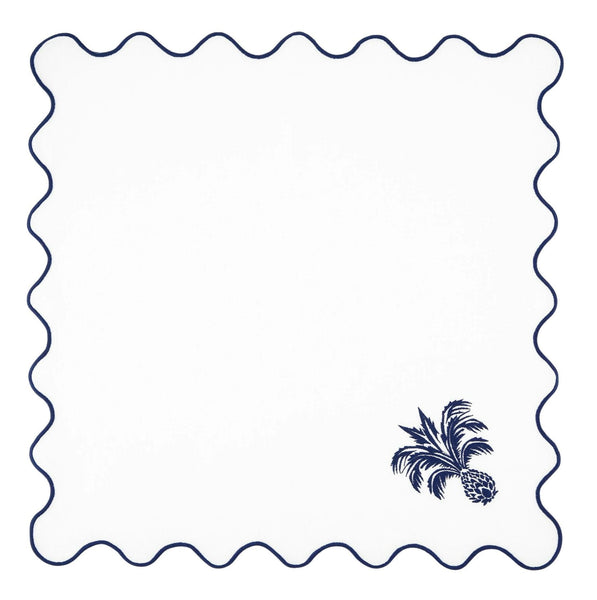 The Aquazzura Casa Ananas Blue Napkin set features white napkins with scalloped edges, adorned with wavy navy blue trim and a small embroidered navy blue pineapple design in one corner.