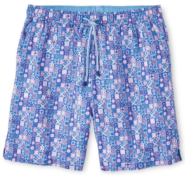 The Peter Millar Mosaic Madness Swim Trunk, from the esteemed Peter Millar brand, features a vibrant blue and pink pattern, a white drawstring waistband, and four-way stretch for ultimate comfort.