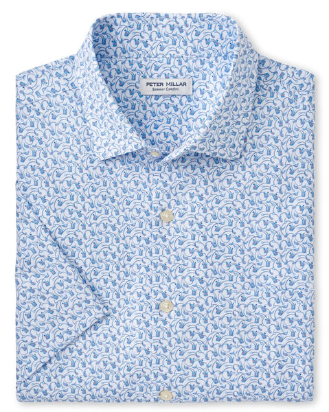 A neatly folded Peter Millar Tee Club Performance Poplin Sport Shirt, featuring a blue and white paisley pattern, button-up long sleeves, and crafted from performance fabric for comfort and durability, with a distinctive Peter Millar label on the collar.