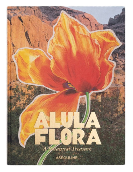 Cover of a book titled "AlUla Flora" by Assouline, showcasing a large orange flower set against rugged rocky cliffs, capturing the vibrant flora of this ancient desert oasis.