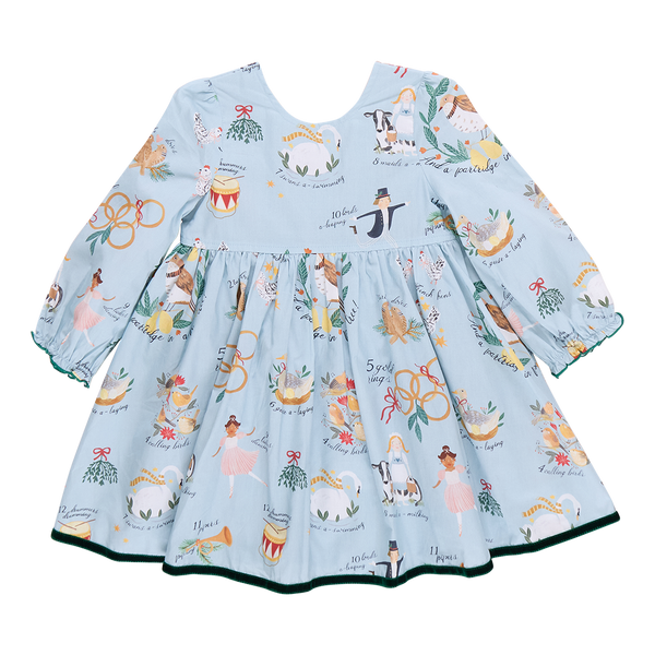 A children's Amma Dress by Pink Chicken, featuring long sleeves and a festive pattern of musicians, floral motifs, and animals inspired by the 12 Days of Christmas, available in blue.