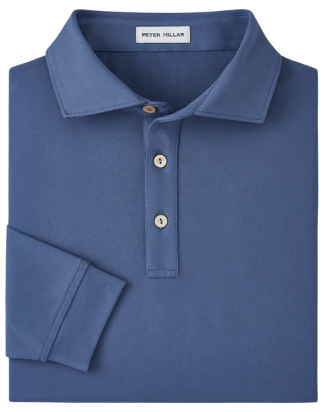 A folded blue Peter Millar Lyons Performance Jersey Long-Sleeve Polo, featuring a collar and three buttons, provides UPF 50+ sun protection to shield you from the sun while its moisture-wicking fabric helps you remain cool and dry.