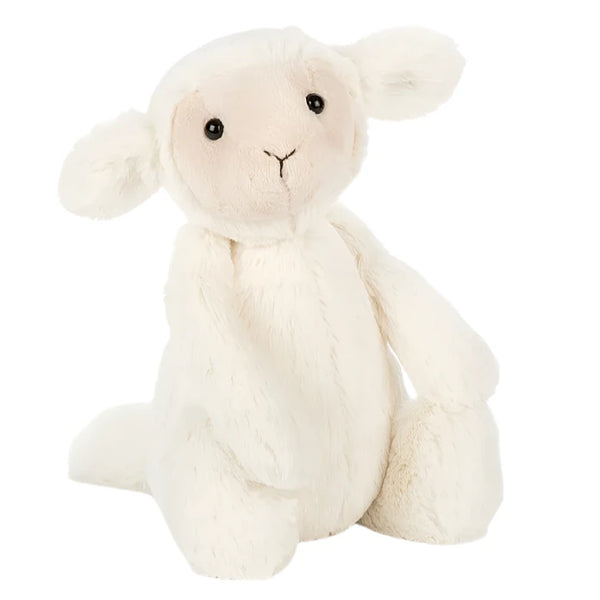 A Jellycat stuffed plushie lamb, known as the Bashful Lamb, sitting on a white background.