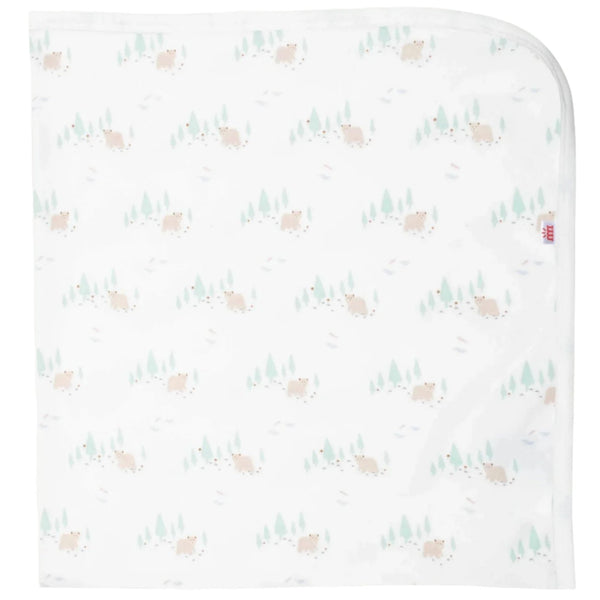 Introducing the Magnetic Me Babe in the Woods Blanket by Magnetic Me: a white organic cotton baby blanket adorned with a playful print of small brown bears and green trees scattered across its surface. This GOTS-certified stroller blanket features rounded edges on one side.