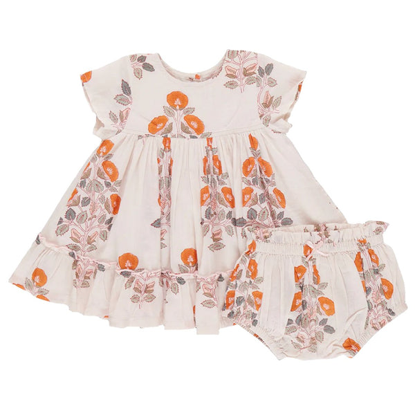 The Pink Chicken Baby Girls' Niley Dress Set features a light-colored vintage baby dress with short sleeves and a floral block print in shades of orange and brown, accompanied by matching bloomers.