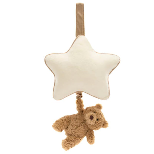 A Jellycat Bartholomew Bear Musical Pull, crafted from recycled fibers, hangs from a looped strap with a small brown teddy bear attached to the bottom.