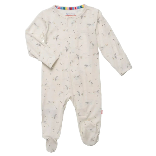 The Magnetic Me Beary Special Delivery Footie, a white baby onesie adorned with a subtle floral pattern, features long sleeves and closed feet. Crafted from eco-friendly TENCEL™, it offers both comfort and sustainability.