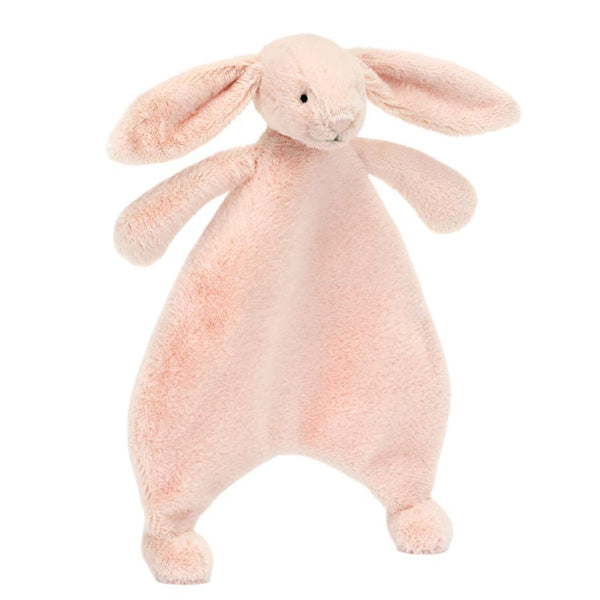 The Jellycat Bashful Bunny Comforter in Blush, crafted from recycled fibers, is a light pink plush toy shaped like a bunny with floppy ears and a flat, soft body, offering an adorable comforter for little ones.