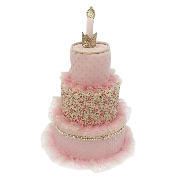 The MON AMI Marie Antoinette Cake Stacker Plush Toy by Mon Ami features a charming design with a pink floral three-tier cake accented with tulle, elegantly topped with a golden crown and candle, creating a stunning masterpiece perfect for any celebration.