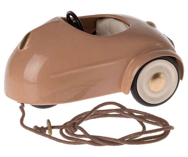 A small, vintage Maileg Mouse Car - Dark Powder with white wheels and a pull string attached.