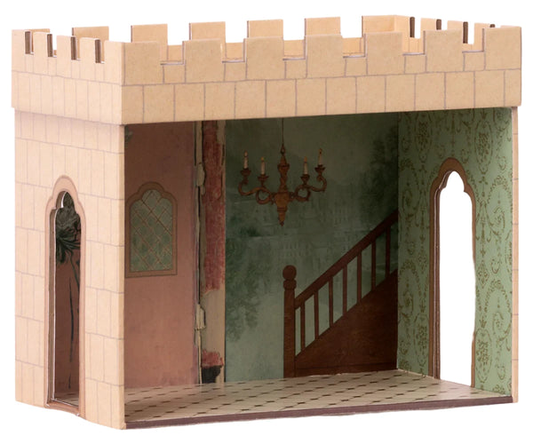 The Maileg Castle Hall by Maileg is a cardboard palace adventure room model that includes a staircase, chandelier, door, and two windows with tiled flooring and decorated walls. It is recommended for ages 3 and up.