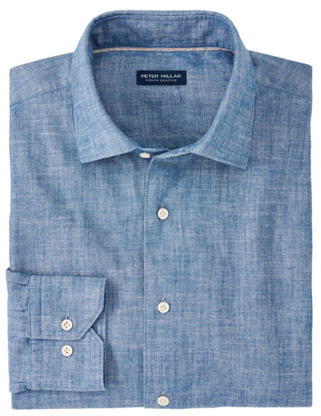 A folded light blue men's cotton sport shirt with a tailored fit, featuring long sleeves and a label inside the collar reading "Peter Millar Japanese Selvedge Sport Shirt" by Peter Millar.