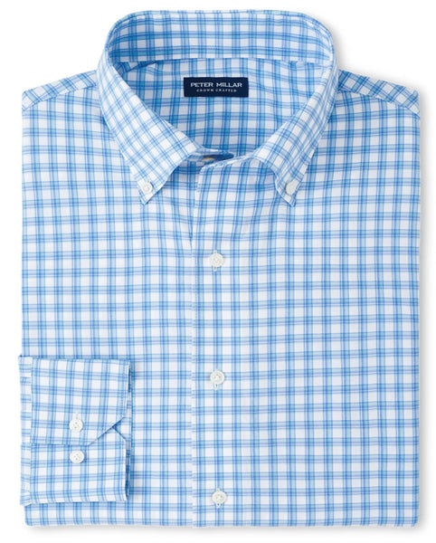 A neatly folded Peter Millar Gibbs Performance Poplin Sport Shirt, featuring a blue and white checkered pattern with a button-down collar, made from moisture-wicking performance fabric for all-day comfort.