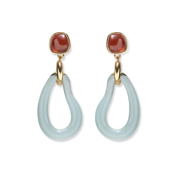 Introducing the Lizzie Fortunato Galina Earrings: a stunning pair showcasing red stone studs and blue teardrop-shaped pendants, each linked by a luxurious handmade glass gold connector.