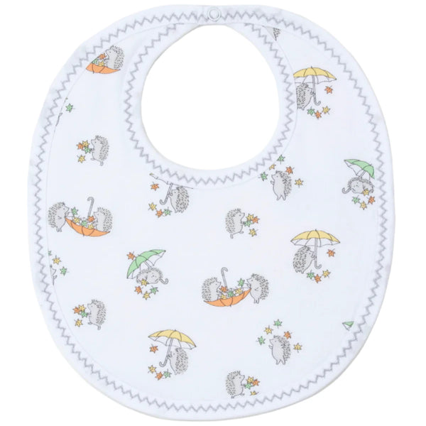 Introducing the Kissy Kissy Hedgehogs Fall Showers Printed Bib by Kissy Kissy. This charming baby bib features a white background adorned with adorable hedgehogs holding umbrellas and small colorful flowers. Crafted from soft Pima cotton, it is designed with zigzag stitching around the edges and a snap closure at the top—ideal for baby mealtime.