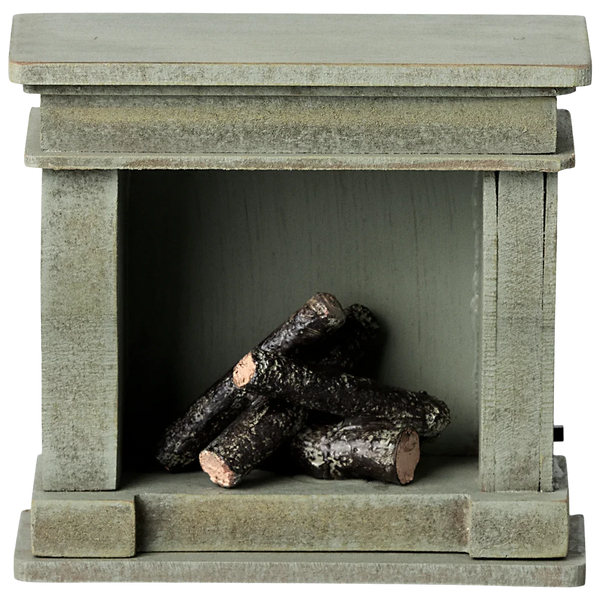 A small, green wooden Maileg Miniature Fireplace by Maileg, featuring a stack of dark, small logs inside.