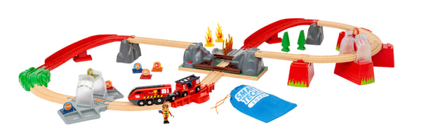 The BRIO World Fire Rescue Smart Tech Set by Brio includes a toy train with red tracks, a fire-themed bridge, green and red ramps, and a fire truck train. It's equipped with accessory figures, signage, and comes with a blue bag labeled "Smart Tech Sound," making it perfect for thrilling adventures.