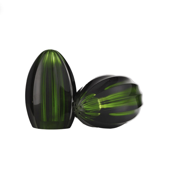 Two green-and-black decorative glass ornaments, with one upright and the other resting horizontally. Both have a glossy finish and a ribbed pattern, reflecting Mario Luca Giusti's aesthetic research into refreshing new shapes are reminiscent of the Mario Luca Bonnie and Clyde Acrylic Salt and Pepper Collections by Mario Luca Giusti.