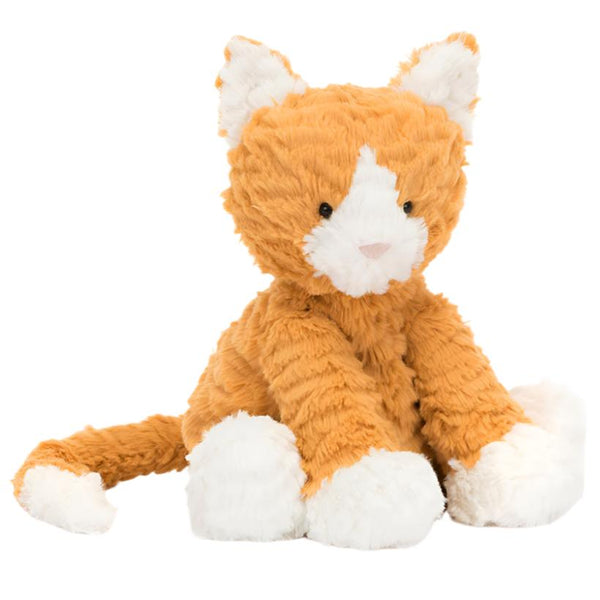 A Jellycat Fuddlewuddle Ginger Cat toy by Jellycat, featuring a fluffy texture and marmalade fur, is seated with its legs extended forward and tail curved to the side.