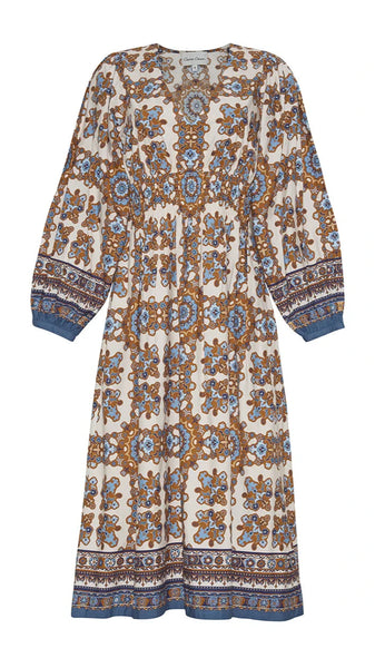 The Cara Cara Ginger Dress by Cara Cara is a long-sleeved, ankle-length fall favorite crafted from Cotton Poplin and adorned with a paisley-inspired pattern in shades of blue, tan, and white.