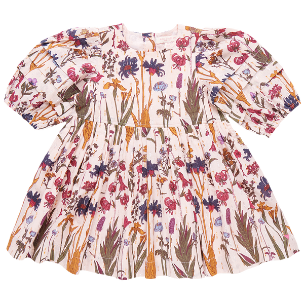 The Pink Chicken Girls' Brooke Dress from Pink Chicken is a long-sleeve, floral-printed dress for children, featuring a gathered waist and glitter button back closure, adorned with a mix of pink, blue, and green patterns on a white background.