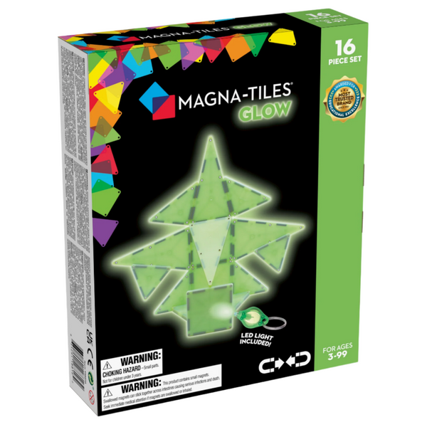 Box of MAGNA-TILES® Glow 16-Piece Set by Magnatiles for ages 3-99, with an LED light included. The box showcases a colorful geometric design on the side and two warning labels at the bottom. These magnetic tile pieces serve as an excellent STEAM learning tool.