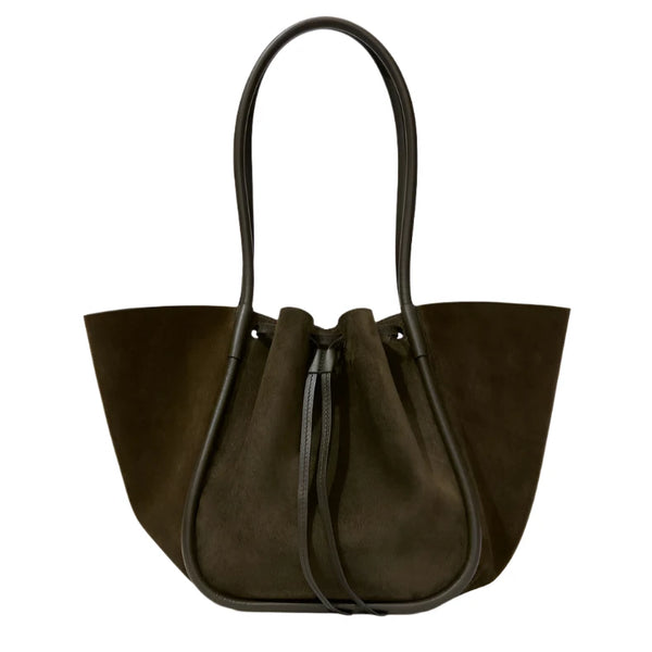 The Proenza Schouler Large Ruched Soft Suede Tote combines elegance and functionality with its sleek black leather handles and stylish drawstring closure.