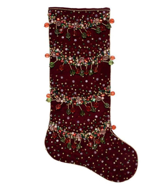 The Kim Seybert Celestial Stocking, ornamented with intricate beadwork and sequin designs, serves as a celestial Christmas piece.