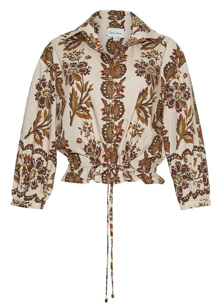 The Cara Cara Hutton Top by Cara Cara is a long-sleeve blouse adorned with a floral and leaf print in shades of brown and beige, featuring a functional drawstring hem at the waist and collar.