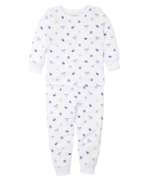 The Kissy Kissy My First Hanukkah Pajama Set by Kissy Kissy is a white Pima cotton infant pajama set with a long-sleeve top and pants, featuring a charming blue and yellow Hanukkah-themed print that includes dreidels, menorahs, stars, and coins.