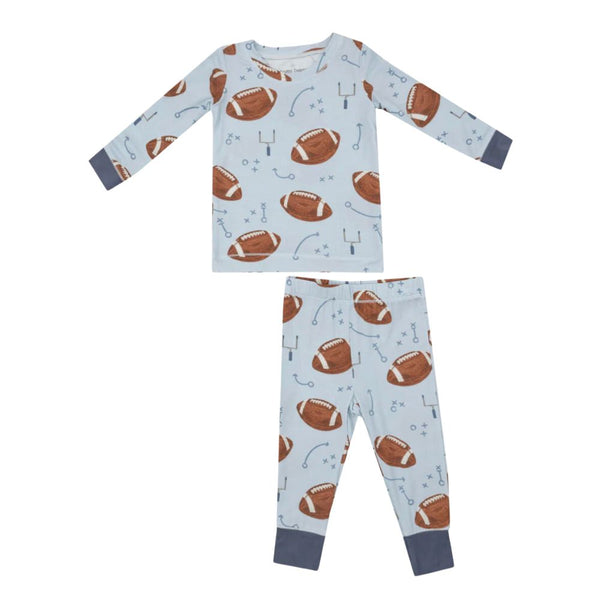 The Angel Dear Footballs Blue LS Loungewear Set by Angel Dear is a children's long-sleeve pajama set that showcases a blue background with a football and sports theme pattern, including illustrations of footballs, goalposts, and plays. Made from soft viscose from bamboo, it’s perfect for sensitive skin and is machine washable for easy care.