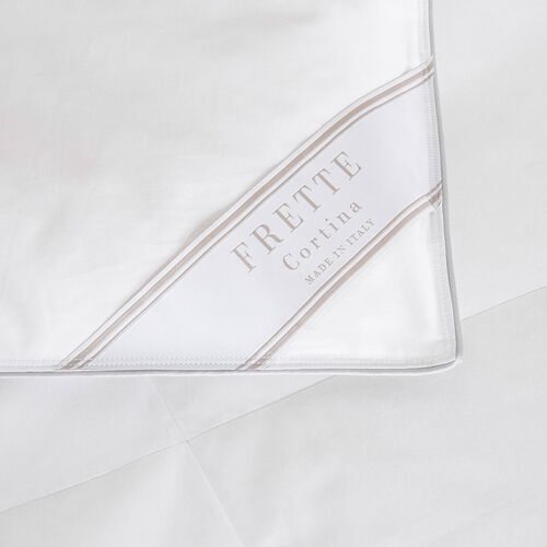 Close-up of a white Frette Cortina Duvet Insert, Light Density with a corner label stating "Frette Cortina Made in Italy.