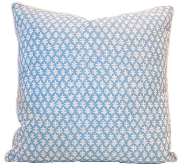 The Burma Sea Glass Outdoor Pillow by Associated Design is a custom 22" x 22" outdoor pillow featuring a blue and white leaf pattern, perfect for adding a touch of elegance to your patio decor.