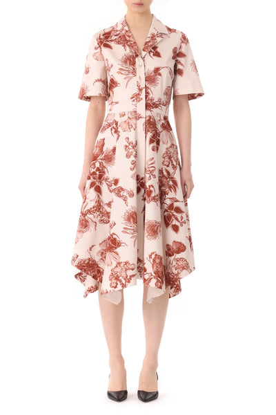 Person wearing a white short-sleeve Jason Wu Collection Forest Floral Shirtdress with red forest floral patterns, featuring a handkerchief hem and black heels.