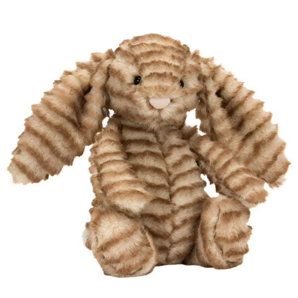 A Jellycat Bashful Luxe Bunny Juniper with striped, textured fur and long floppy ears sits upright, flaunting its golden-brown fur and a fluffy cream bobtail.