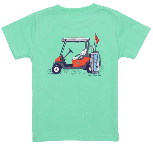 The Properly Tied Boys' Country Club Tee is a classic green boys' tee featuring a graphic of a red golf cart, a golf bag with clubs, and a red flag on the back—perfect for everyday wear.