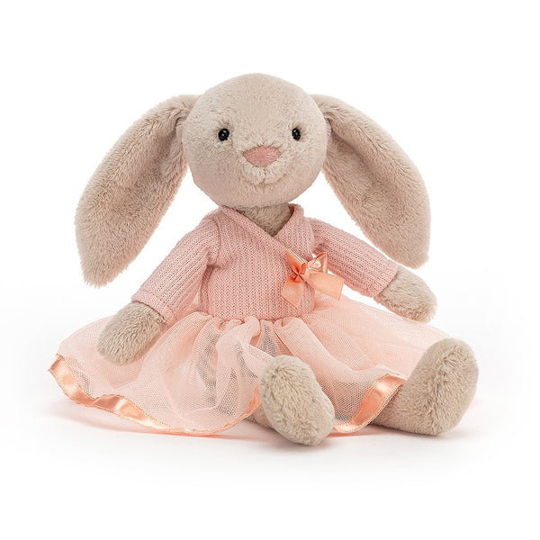 A stuffed bunny in a pink dress, known as Lottie Bunny Ballet, sitting on a white background. You can buy this adorable plush toy from Jellycat.