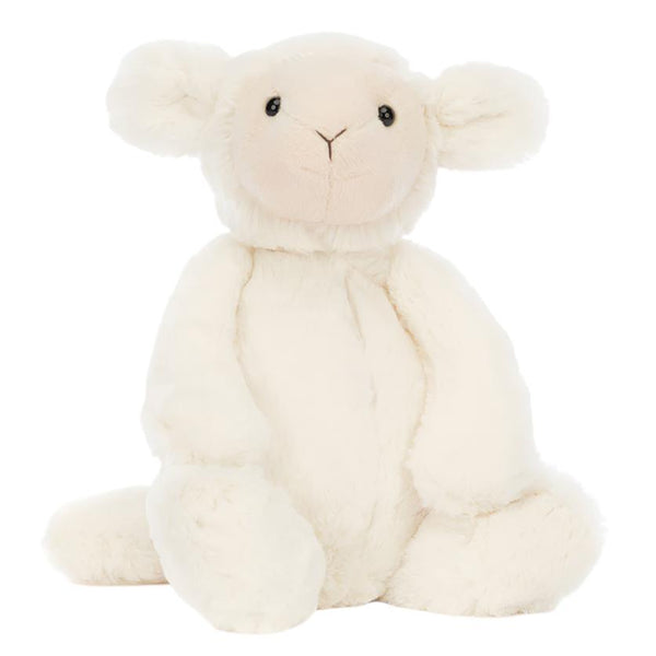 A fluffy, medium-sized Jellycat Bashful Lamb with rounded ears and soft buttercream fur sits upright on a plain background, embodying the perfect cuddly plush toy.